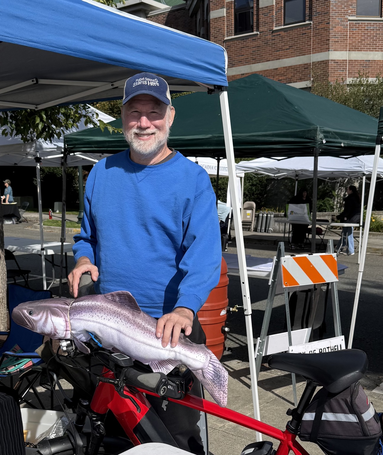 MRC member with a salmon on a bike.
