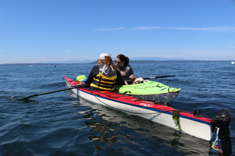 Two MRC volunteers working together on kayaks.